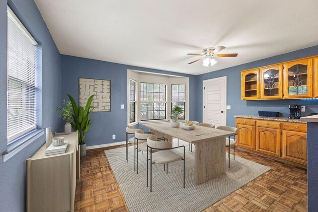 dining area featuring baseboards and a ceiling fan