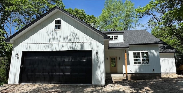 modern farmhouse style home with a shingled roof and an attached garage