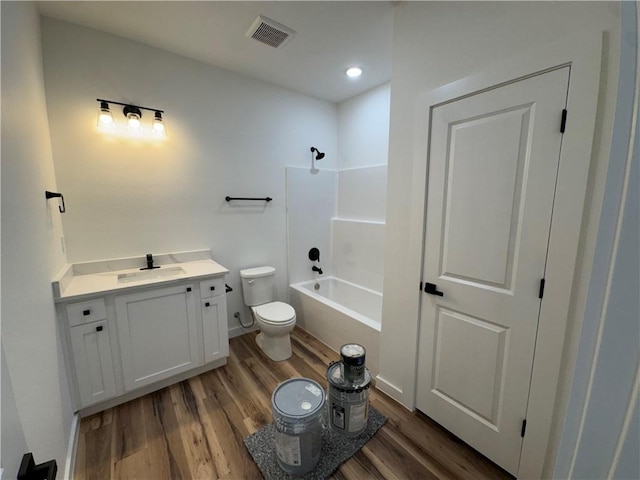 13537 Little Elm Rd, Farmington, AR 72730 - bathroom featuring toilet, wood finished floors, vanity, bathing tub / shower combination, and recessed lighting