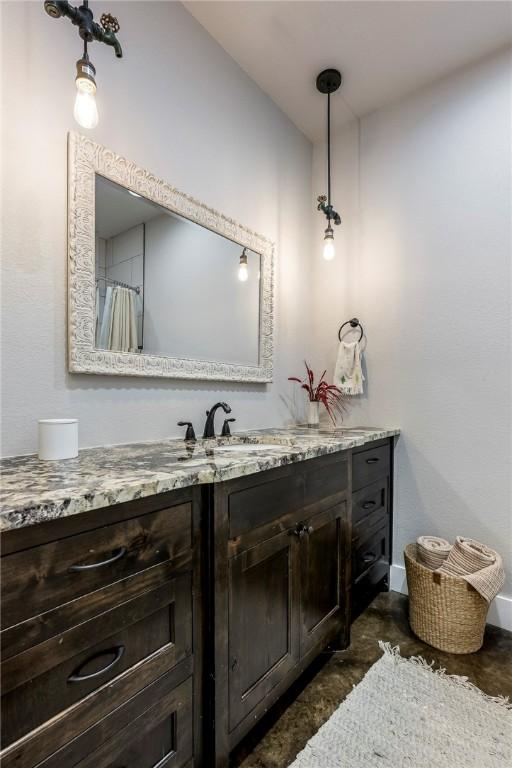 bathroom with baseboards and vanity