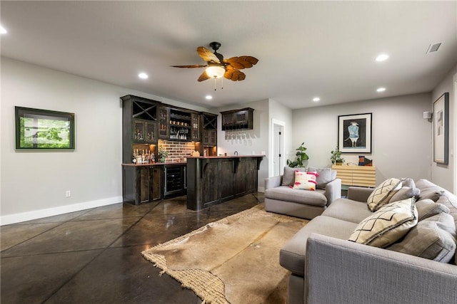 living area with indoor wet bar, recessed lighting, baseboards, and finished concrete flooring