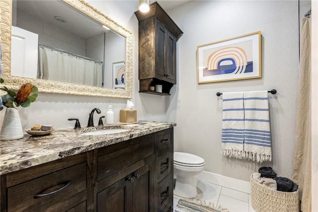 bathroom featuring vanity, baseboards, and toilet