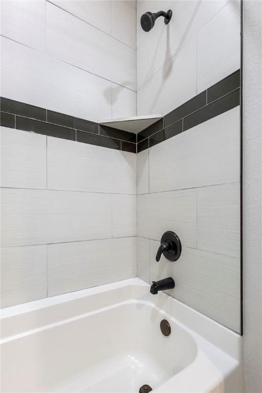 bathroom with bathing tub / shower combination