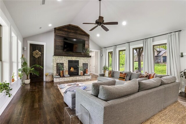 living room featuring lofted ceiling, wood finished floors, a stone fireplace, ceiling fan, and recessed lighting