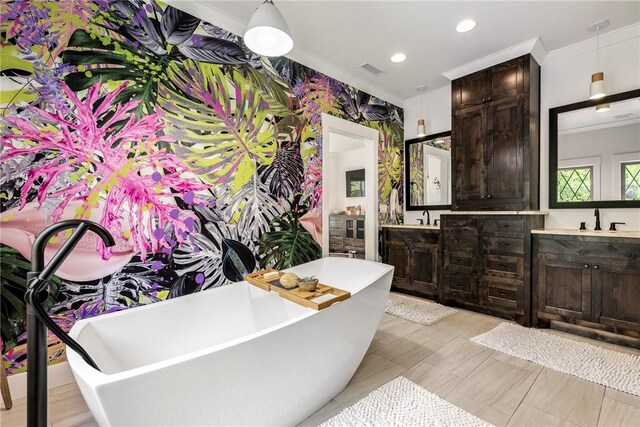 full bath featuring crown molding, a freestanding tub, visible vents, and vanity