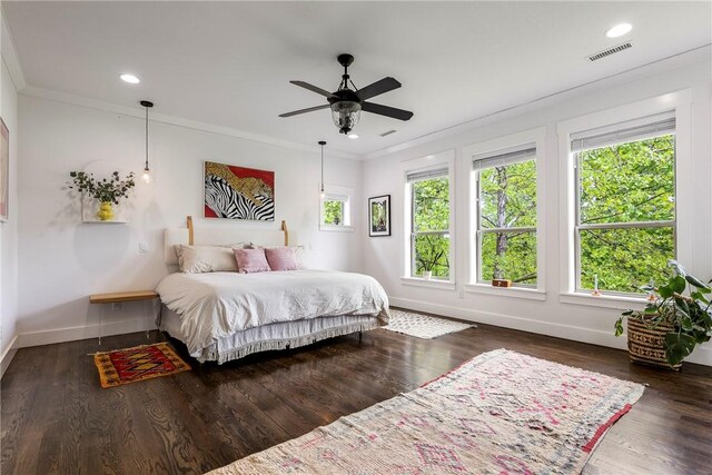 bedroom with baseboards, visible vents, and ornamental molding
