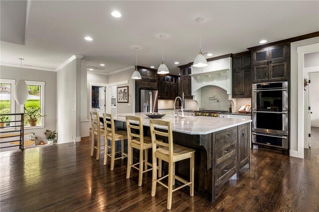 kitchen with ornamental molding, dark wood-type flooring, recessed lighting, backsplash, and stainless steel appliances