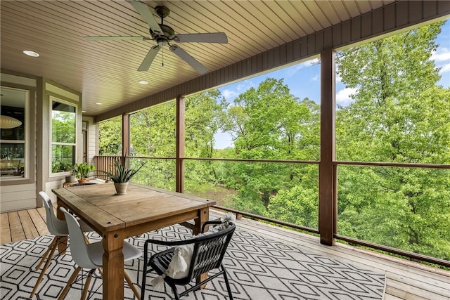 sunroom / solarium featuring ceiling fan and outdoor dining space