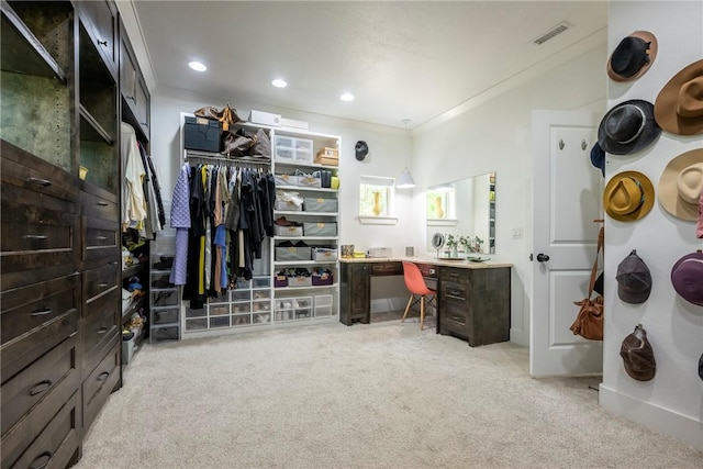 walk in closet with visible vents and light carpet