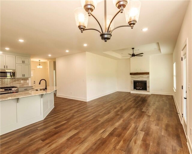 kitchen featuring appliances with stainless steel finishes, dark wood-style flooring, and recessed lighting