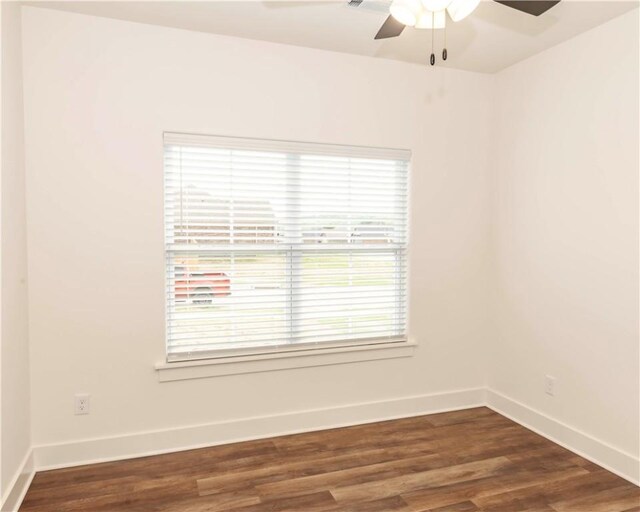 unfurnished room featuring ceiling fan, dark wood-style floors, and baseboards