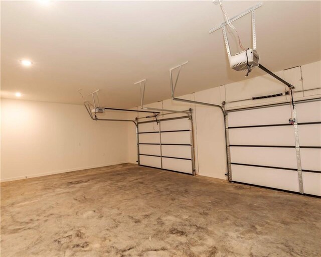 garage with a garage door opener and recessed lighting