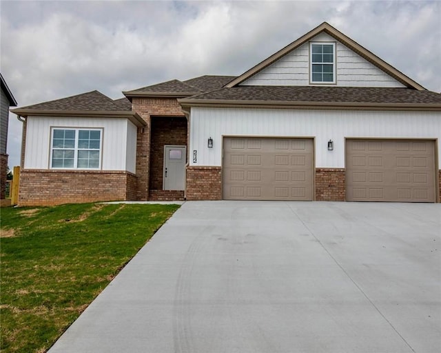 212 Nebo St, Prairie Grove, AR 72753 - view of front facade featuring brick siding, an attached garage, a shingled roof, concrete driveway, and a front lawn