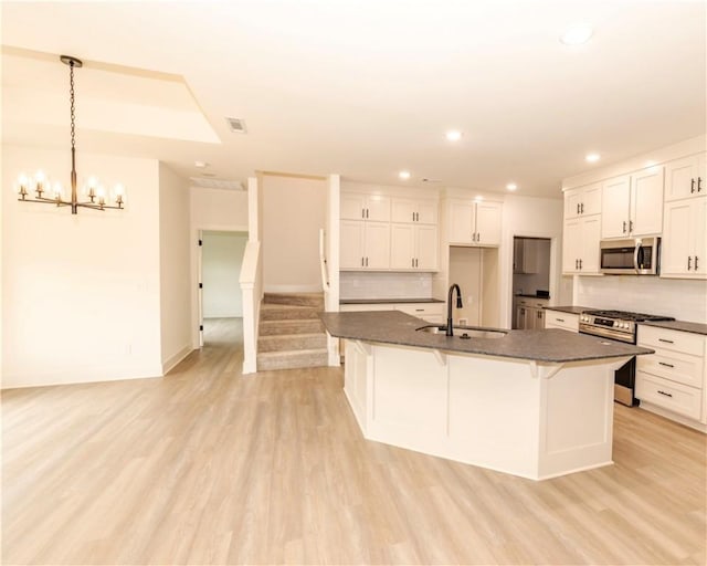 212 Nebo St, Prairie Grove, AR 72753 - kitchen with recessed lighting, a sink, dark countertops, white cabinets, and appliances with stainless steel finishes