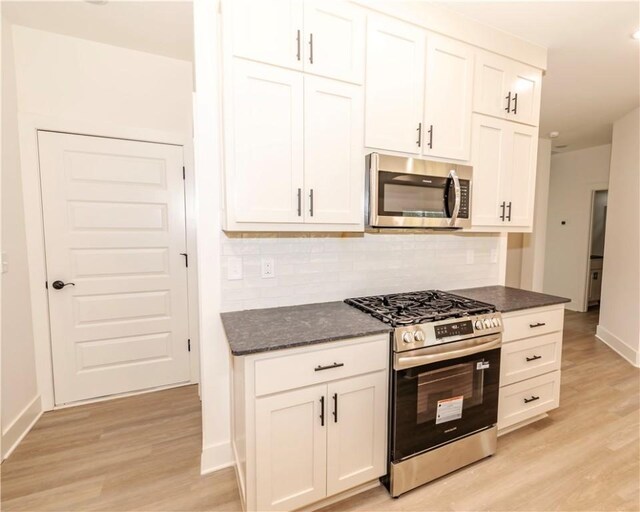 212 Nebo St, Prairie Grove, AR 72753 - kitchen with stainless steel appliances, backsplash, baseboards, and light wood-style flooring