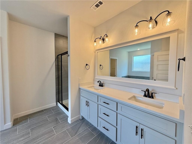 full bathroom featuring double vanity, visible vents, a sink, and a stall shower