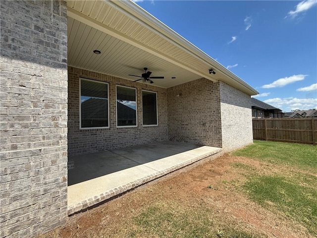 view of patio / terrace with a ceiling fan and fence