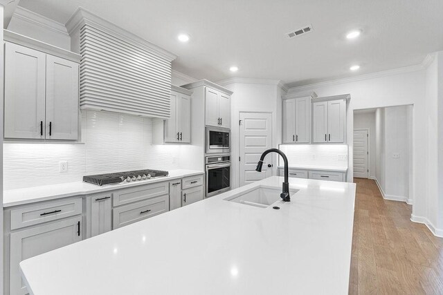 909 Budrio Ave, Tontitown, AR 72762 - kitchen featuring stainless steel appliances, a sink, ornamental molding, backsplash, and ventilation hood
