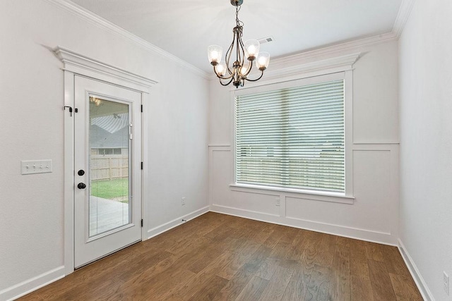 909 Budrio Ave, Tontitown, AR 72762 - unfurnished dining area with a chandelier, crown molding, dark wood finished floors, and baseboards