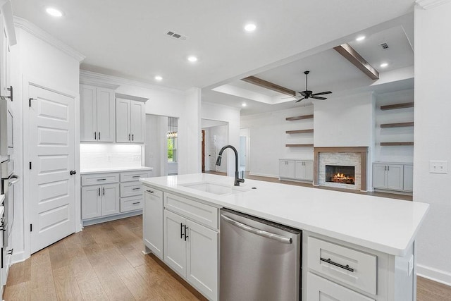 909 Budrio Ave, Tontitown, AR 72762 - kitchen featuring stainless steel dishwasher, a sink, ceiling fan, light wood-type flooring, and light countertops