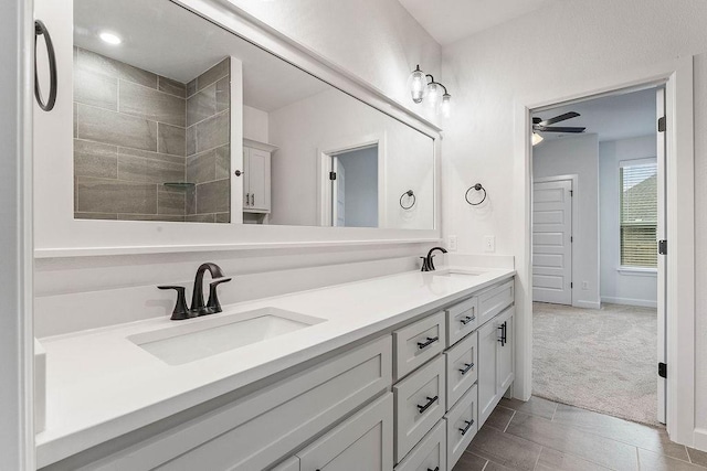 909 Budrio Ave, Tontitown, AR 72762 - bathroom featuring double vanity, ceiling fan, and baseboards