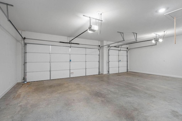 909 Budrio Ave, Tontitown, AR 72762 - garage featuring a garage door opener and baseboards