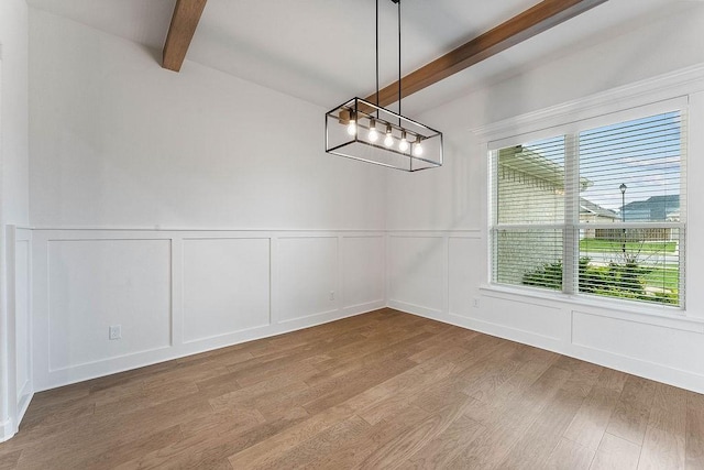 909 Budrio Ave, Tontitown, AR 72762 - unfurnished dining area with beam ceiling, wood finished floors, a decorative wall, and wainscoting