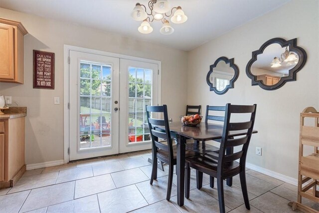 5213 S 62nd St, Rogers, AR 72758 - dining area with a chandelier, french doors, baseboards, and light tile patterned flooring