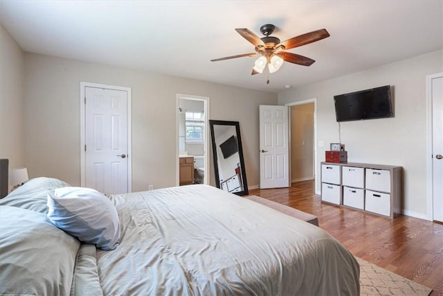 5213 S 62nd St, Rogers, AR 72758 - bedroom with wood finished floors, baseboards, a ceiling fan, and connected bathroom