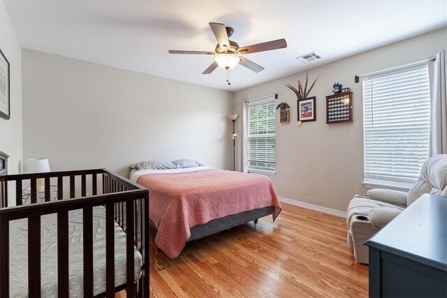 5213 S 62nd St, Rogers, AR 72758 - bedroom with light wood finished floors, baseboards, and a ceiling fan