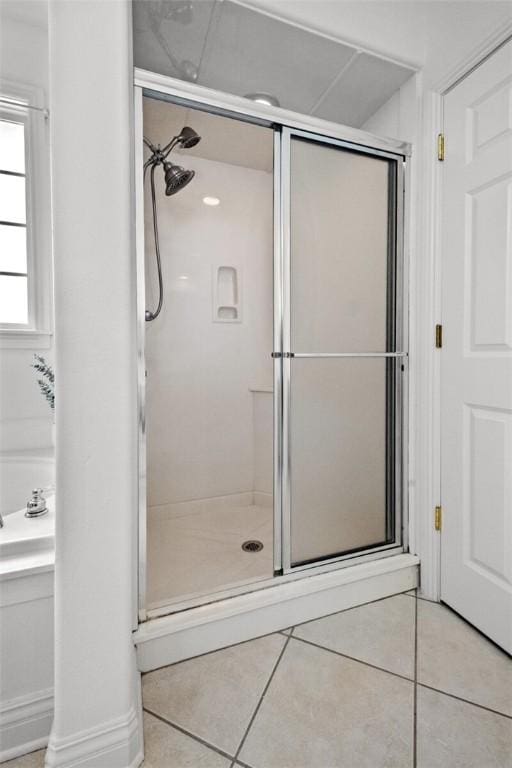full bathroom featuring tile patterned floors and a stall shower