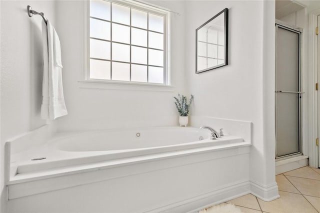 full bath featuring tile patterned floors, a shower stall, and a garden tub