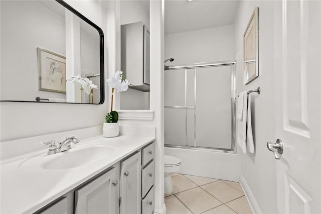 2306 SW Clover Ct, Bentonville, AR 72712 - bathroom with toilet, baseboards, tile patterned flooring, vanity, and combined bath / shower with glass door