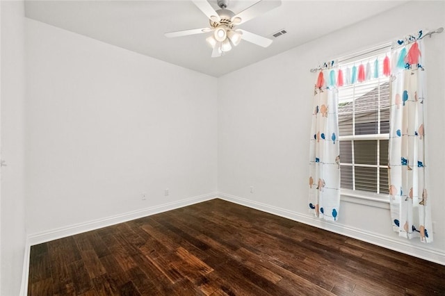 spare room featuring ceiling fan, baseboards, visible vents, and wood finished floors
