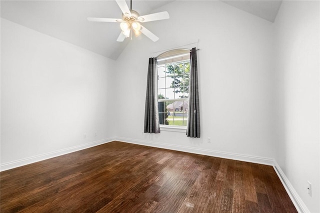 empty room with baseboards, a ceiling fan, vaulted ceiling, and dark wood-style flooring