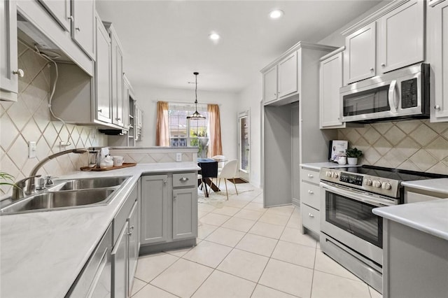 kitchen featuring recessed lighting, a sink, tasteful backsplash, and stainless steel appliances