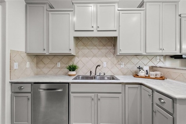 kitchen with a sink, light countertops, and stainless steel dishwasher