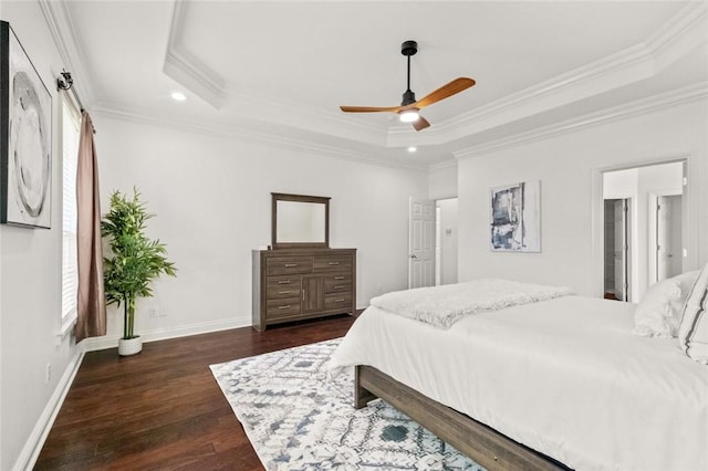 bedroom with recessed lighting, ornamental molding, a tray ceiling, and dark wood-style floors