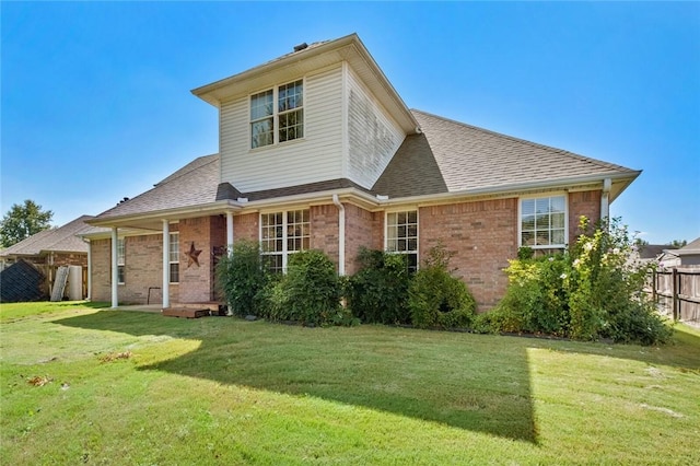 2306 SW Clover Ct, Bentonville, AR 72712 - back of house with fence, brick siding, and a lawn