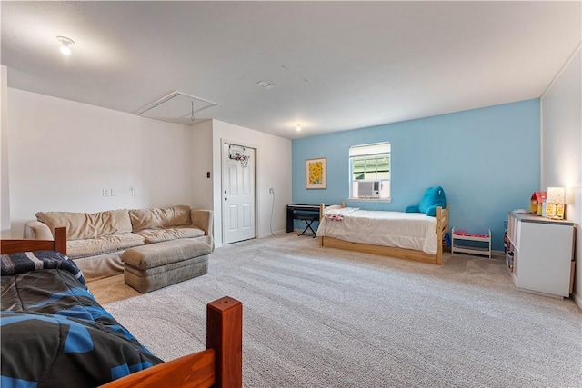 bedroom with light carpet and attic access