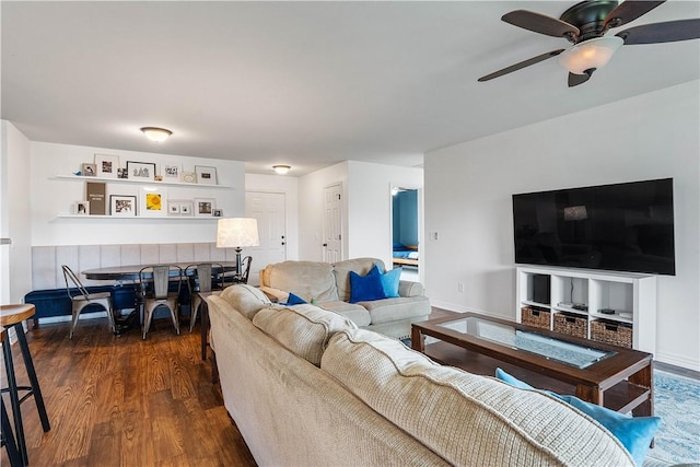 living room with ceiling fan and dark wood-style floors