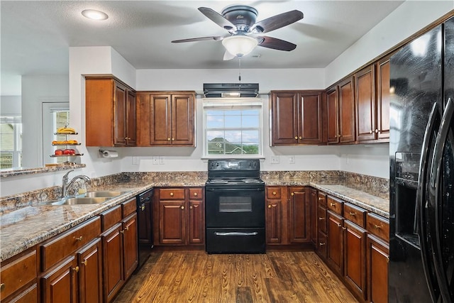 kitchen with dark wood-style flooring, ceiling fan, a sink, plenty of natural light, and black appliances