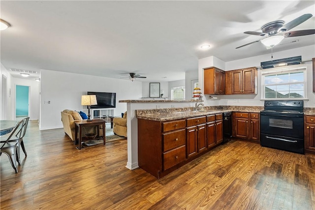 kitchen featuring dark wood-style flooring, a ceiling fan, a sink, and black appliances
