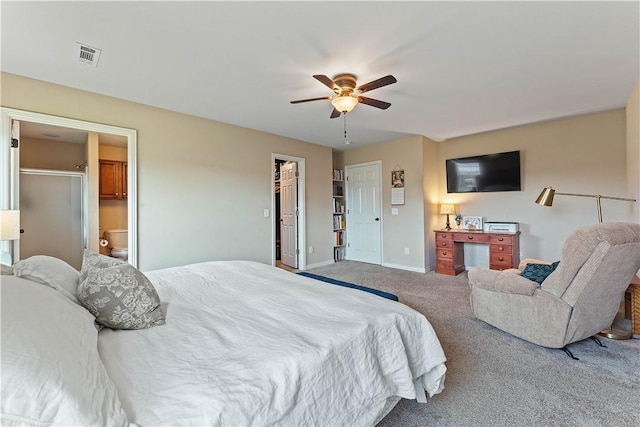 bedroom with ceiling fan, visible vents, baseboards, carpet floors, and ensuite bath