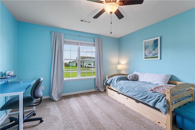 carpeted bedroom featuring baseboards, visible vents, and ceiling fan