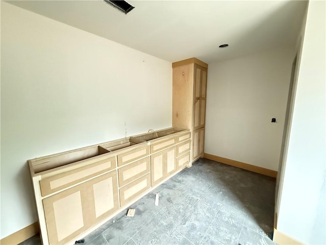 empty room with visible vents and baseboards