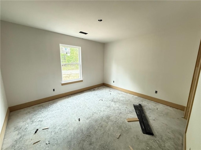 spare room with baseboards