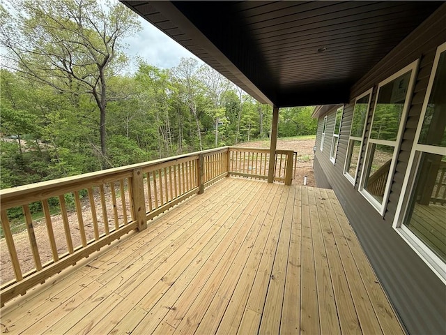 wooden terrace with a wooded view