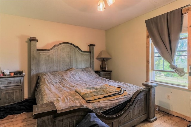 bedroom featuring baseboards and wood finished floors