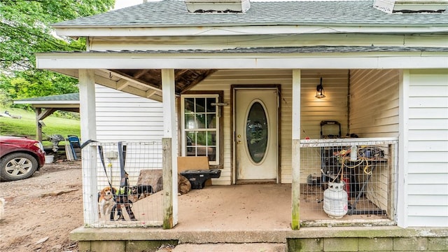 property entrance with roof with shingles